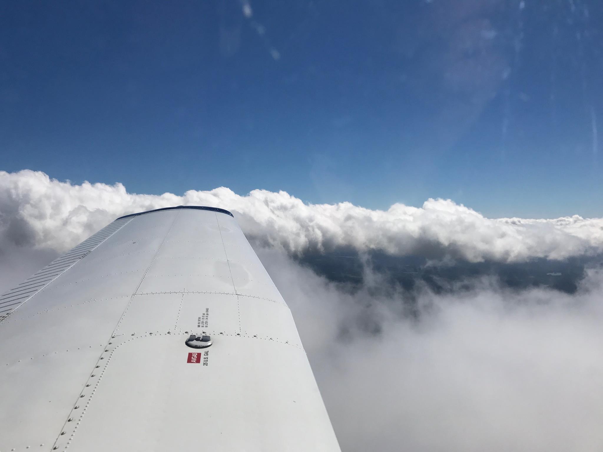 Wing above clouds